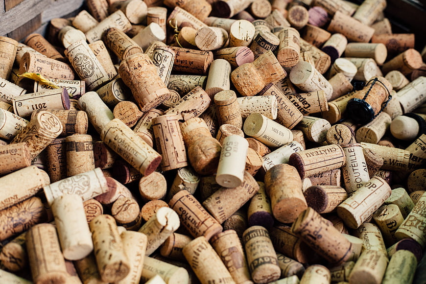 Pile of used wine corks with vintage labels