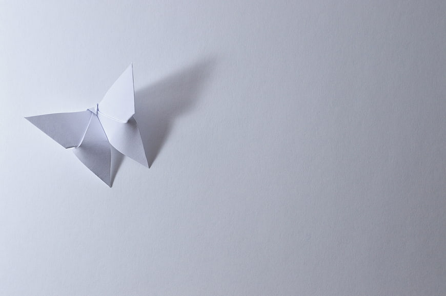 White Origami Butterfly on Light Gray Background
