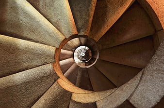 Top-down view of a textured stone spiral staircase