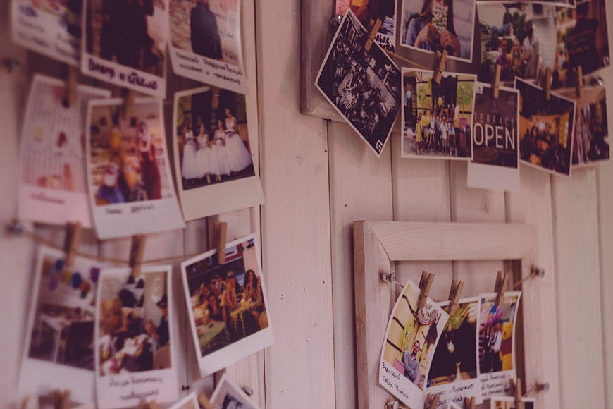 Vintage Polaroid Photos Hanging on Wooden Wall Display