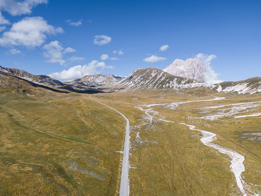 Aerial View of Winding Mountain Road in Alpine Valley