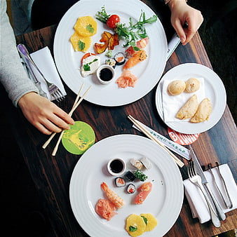 Top view of sushi and appetizers on wooden table