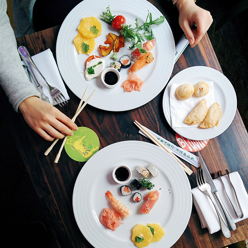 Top view of sushi and appetizers on wooden table