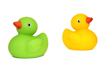 Green and yellow rubber duck toys isolated on white background