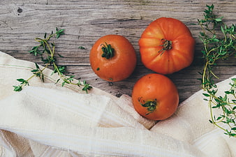 Fresh Heirloom Tomatoes and Herbs on Rustic Wood