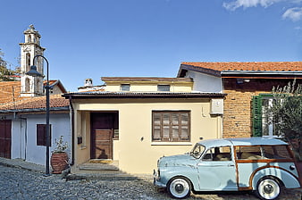 Vintage Light Blue Car Parked in Mediterranean Village