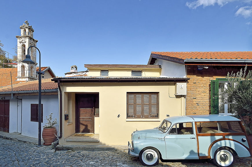 Vintage Light Blue Car Parked in Mediterranean Village