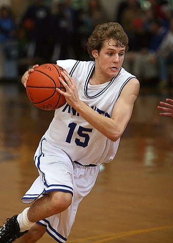 High School Basketball Player Dribbling on Court