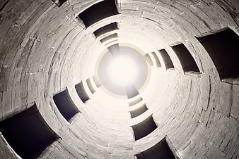 Looking Up Inside A Tall Concrete Silo Tower With Circular Windows