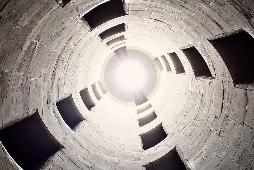 Looking Up Inside A Tall Concrete Silo Tower With Circular Windows