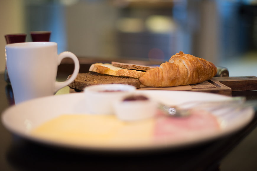 Continental breakfast with croissant, toast, and coffee