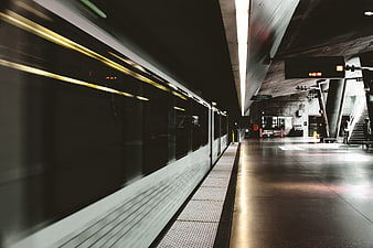 Motion blur train arriving at modern subway station platform