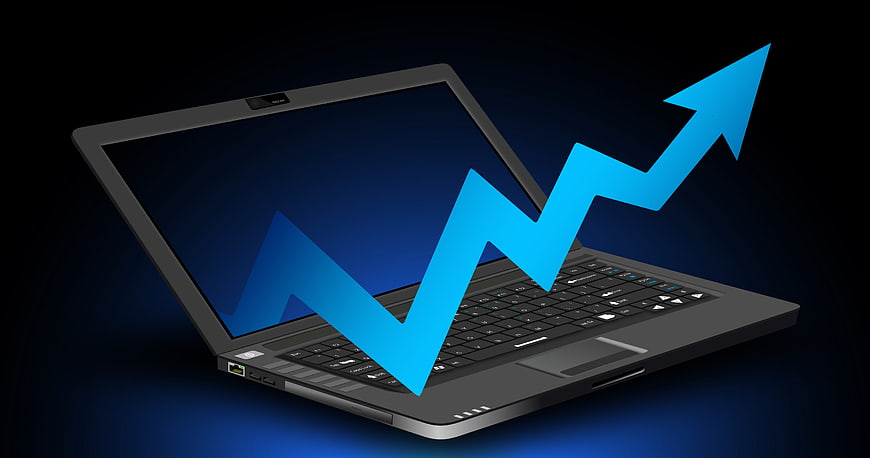 Laptop with Rising Blue Arrow Graph on Dark Background