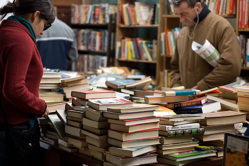 Woman and man browsing books at a second-hand bookstore