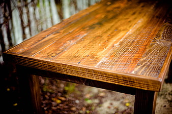 Close-up of rustic wooden table surface with natural grain texture