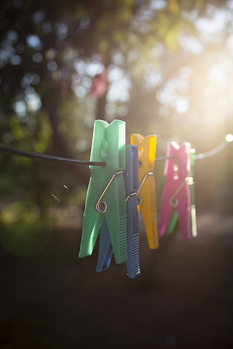 Colorful clothespins hanging on a line in sunlight