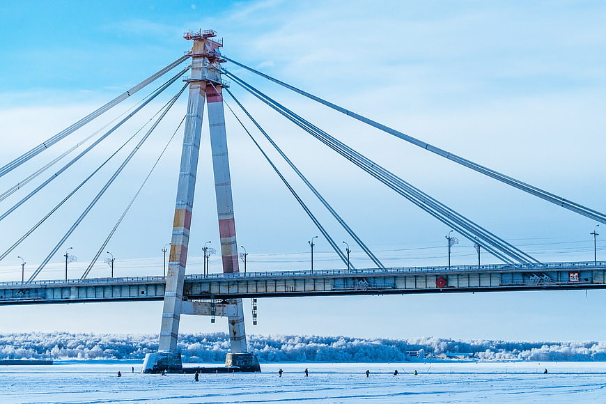 Cable-stayed bridge over frozen river in winter