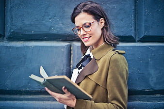 Woman with Glasses Reading Book Outdoors