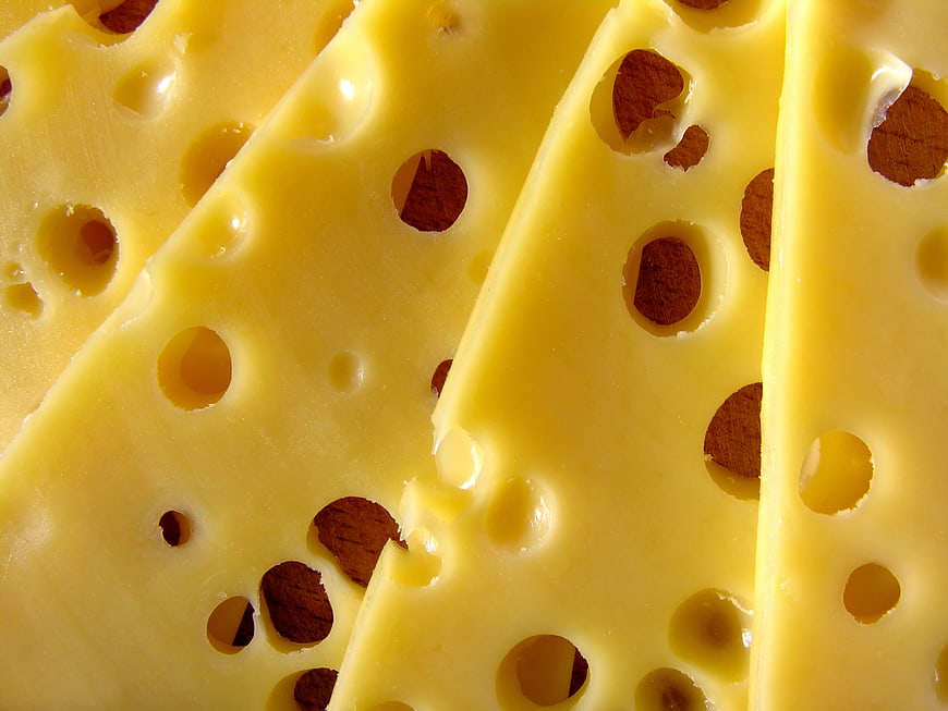 Close-up of Swiss cheese slices with holes