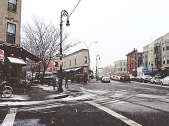 Snowy City Street Intersection with Traffic and Buildings