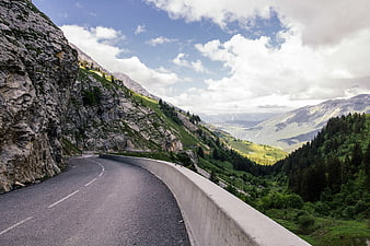 Winding Mountain Road Through Green Alpine Valley