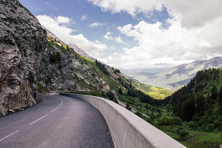Winding Mountain Road Through Green Alpine Valley