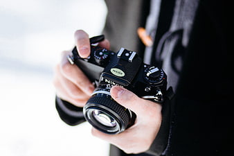 Close-up of Hands Holding Vintage Nikon Film Camera