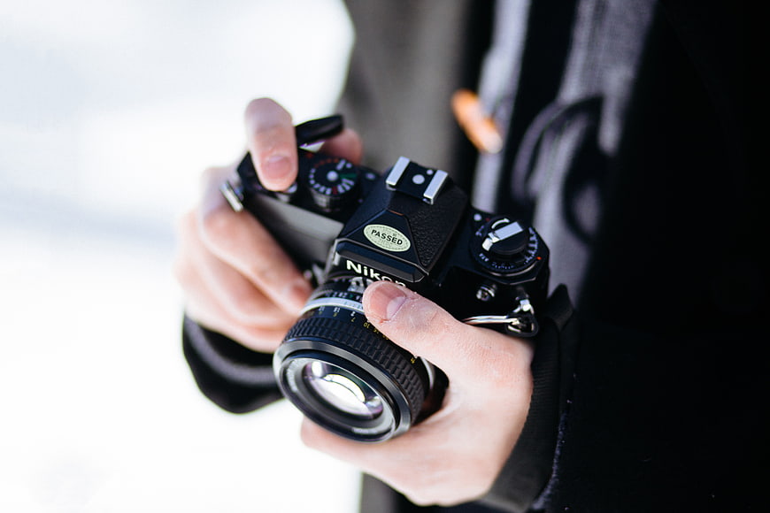 Close-up of Hands Holding Vintage Nikon Film Camera