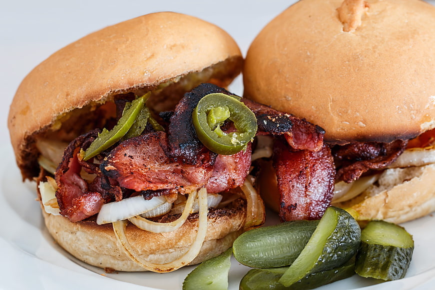 Close-up of bacon burgers with jalapenos and pickles