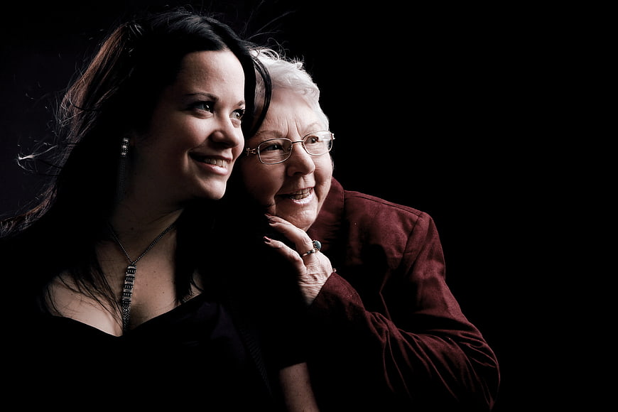 Emotional Portrait of Mother and Daughter Smiling Together