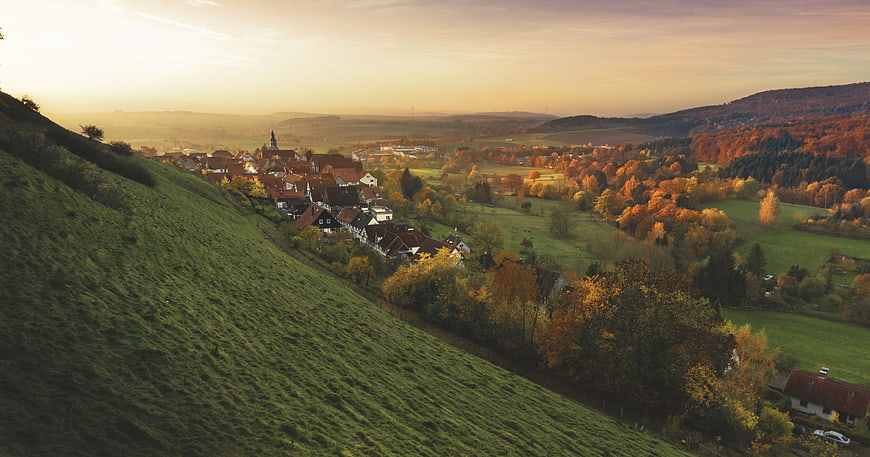 Panoramic View of European Village in Autumn Valley at Sunset