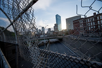 Urban Cityscape View Through Chain Link Fence