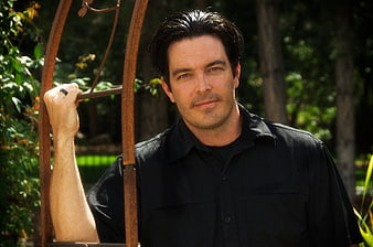 Portrait of Handsome Man in Black Shirt Outdoors