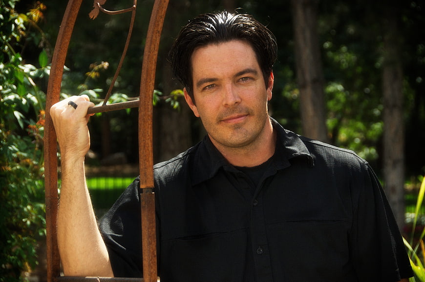 Portrait of Handsome Man in Black Shirt Outdoors