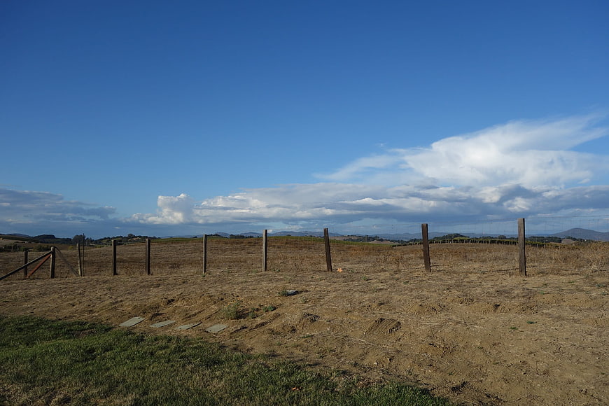 Rural landscape with wooden fence and blue sky