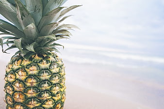 Fresh Pineapple on Beach with Ocean Background