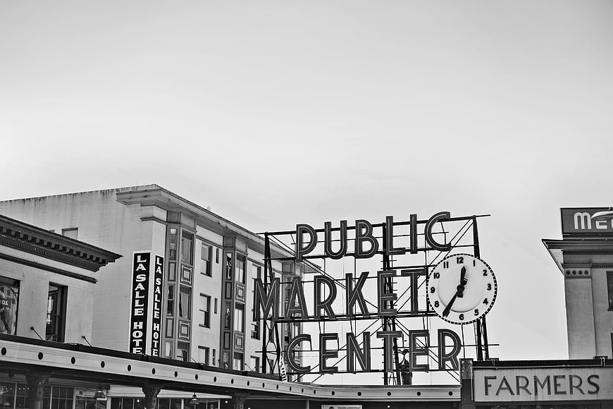 Black and white Public Market Center sign with clock