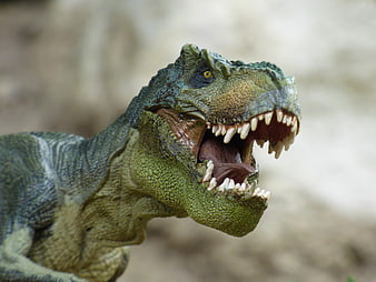 Close-up of roaring green T-Rex toy dinosaur figurine