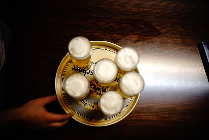 Overhead view of six beer glasses on a tray