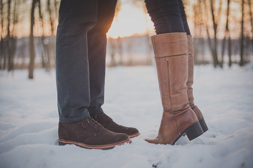 Couple's Boots in Snow at Sunset