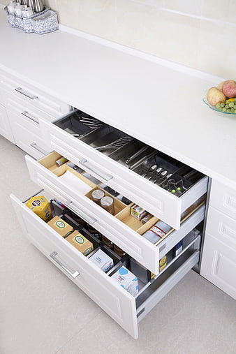 White Kitchen Drawers With Organized Utensils And Food Storage