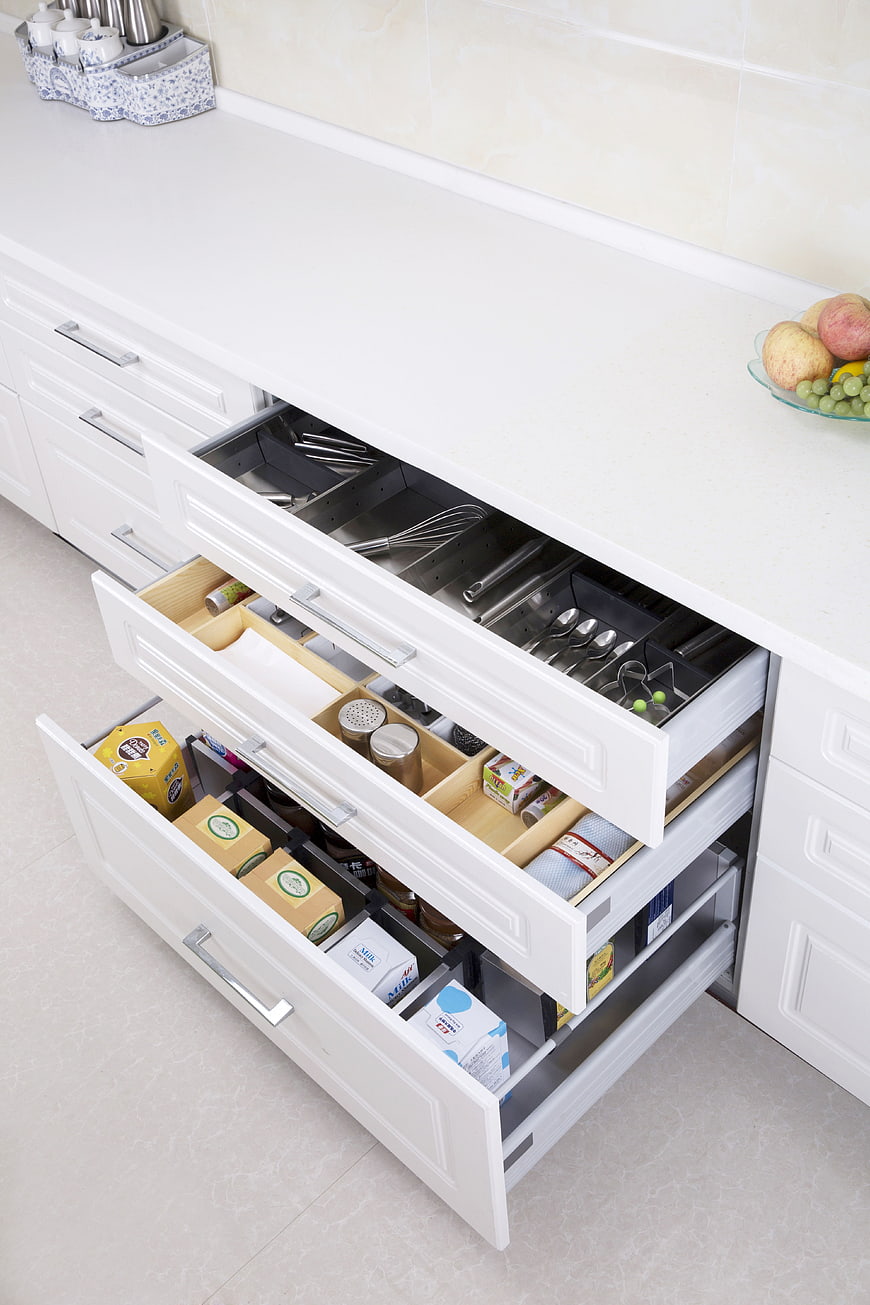 White Kitchen Drawers With Organized Utensils And Food Storage