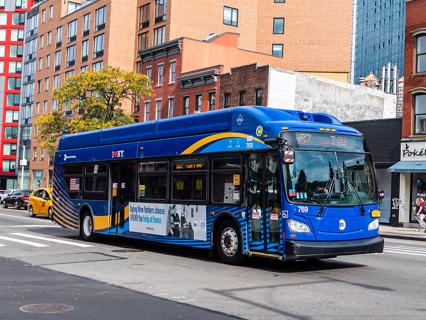 Blue MTA Bus Driving on City Street