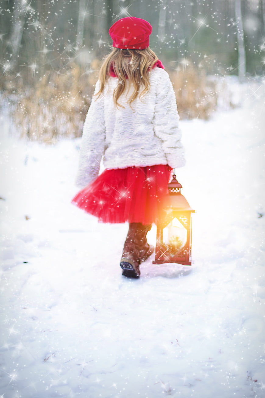 Little Girl in Red Walking in Snow with Lantern