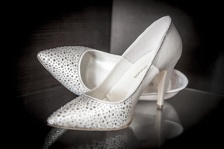 White Rhinestone Wedding Heels on Reflective Surface