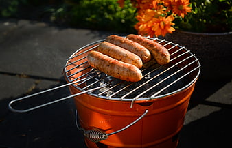 Grilling Sausages on a Portable Outdoor BBQ Grill