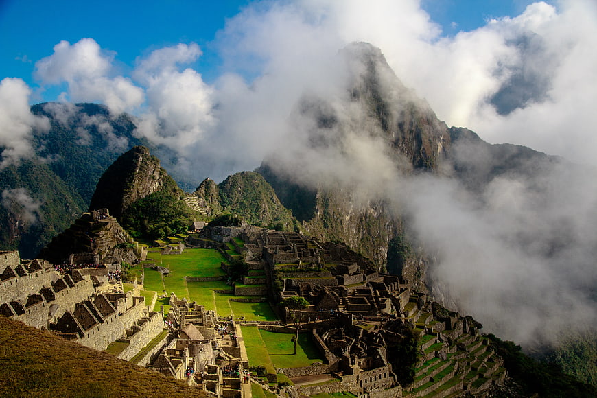 Machu Picchu ruins with Huayna Picchu mountain and clouds