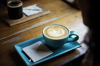 Blue Cup of Cappuccino with Heart Latte Art on Wooden Table