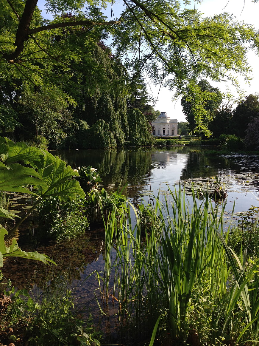 Serene Garden Pond with Classical Pavilion in Background