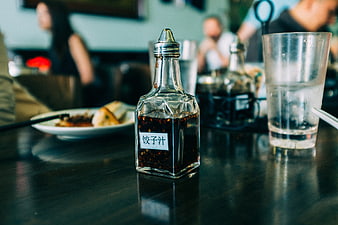 Glass soy sauce bottle with Chinese label on restaurant table